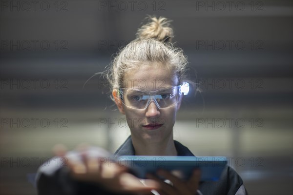 Young logistician working with scan glasses
