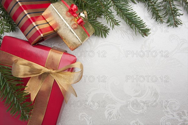 Silk christmas background with gifts and pine branches