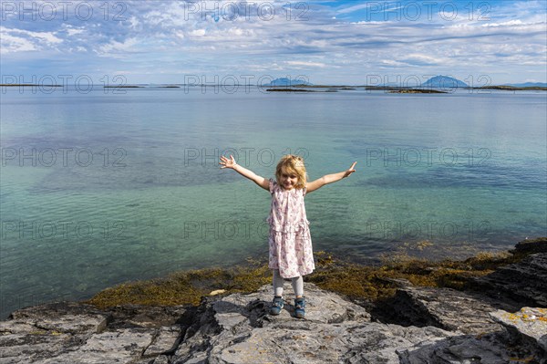Little girl on a rock