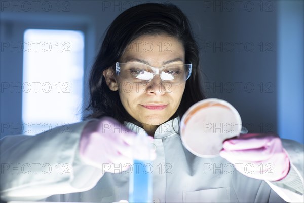 Middle aged technician in lab with lab coat