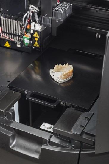 Open 3D printer with finished 3D printed dental implant bridge