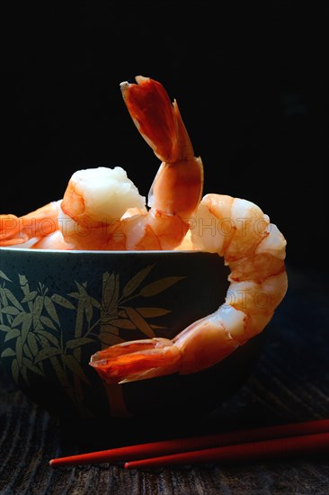 Cooked prawns in shell with chopsticks