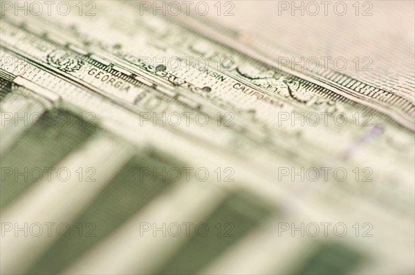 Macro of the back of the U.S. five dollar bill showing small state names as anti-counterfeit measure