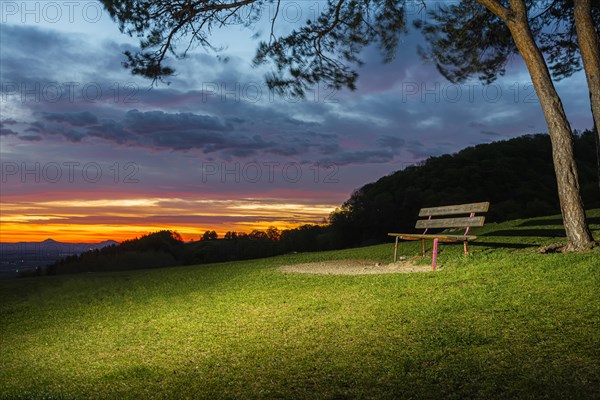 Park bench at sunrise on the Hohenbol below the Teck