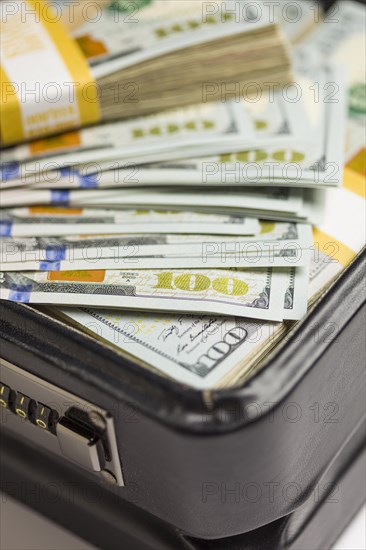 Abstract stacks of newly designed U.S. one hundred dollar bills in briefcase