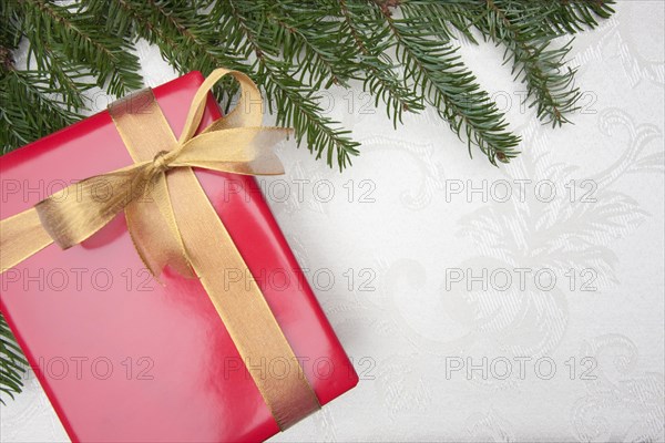 Silk christmas background with gift and pine branches