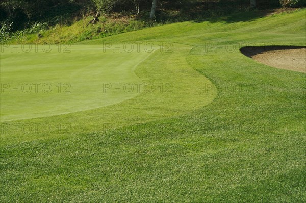 Abstract of bunkers and putting green on a spring day