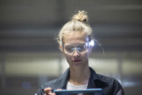 Young logistician working with scan glasses