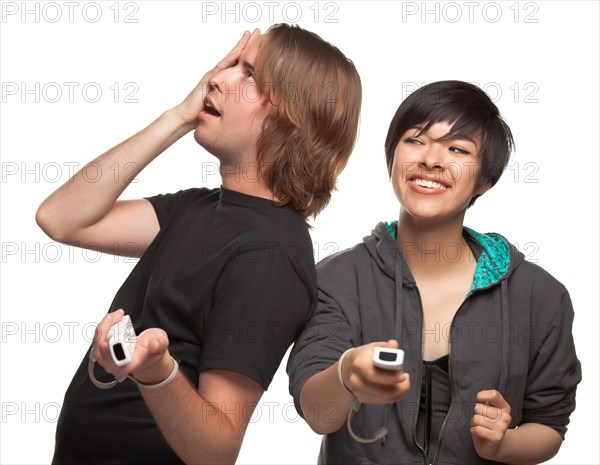Diverse couple with video game controllers having fun isolated on a white background