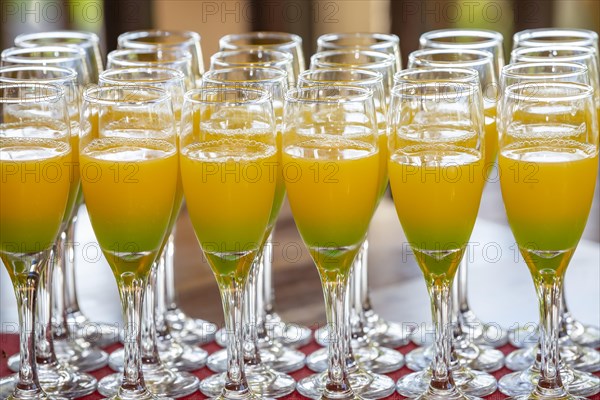 Glass of orange juice cocktail during a wedding party at Domaine 7 Cascades