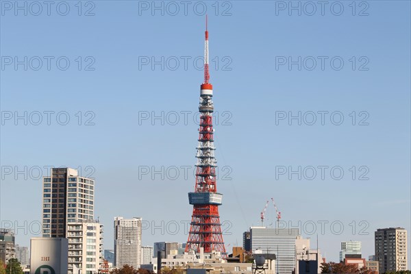 Cityscape with Tokyo Tower in front of blue sky
