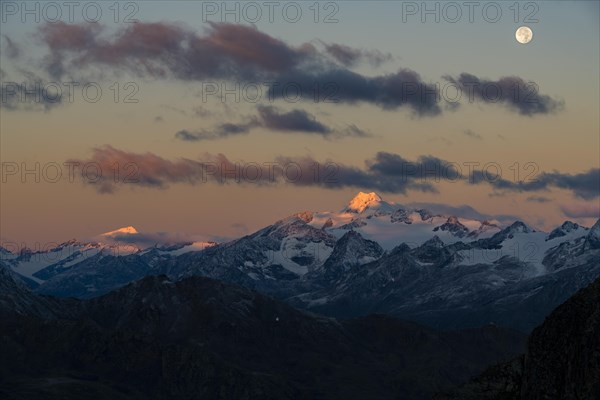 Full moon over summit of Oetztaler Wildspitze