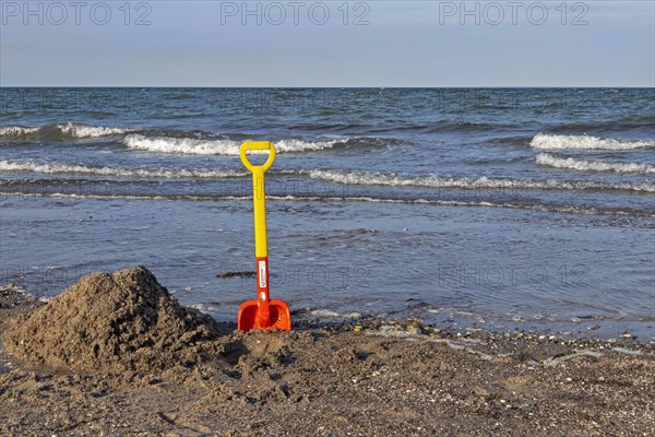Children's shovel on the beach