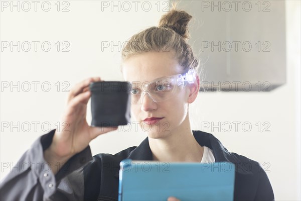 Young logistician working with scan glasses