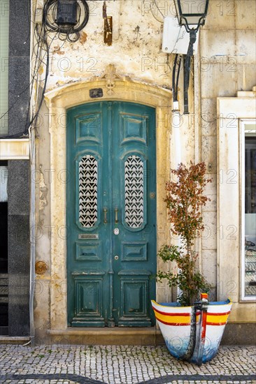 The turquoise wooden door on the promenade in Olhao