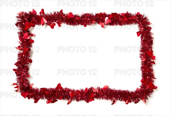 Red tinsel with hearts border frame shape on a white background ready for your own message