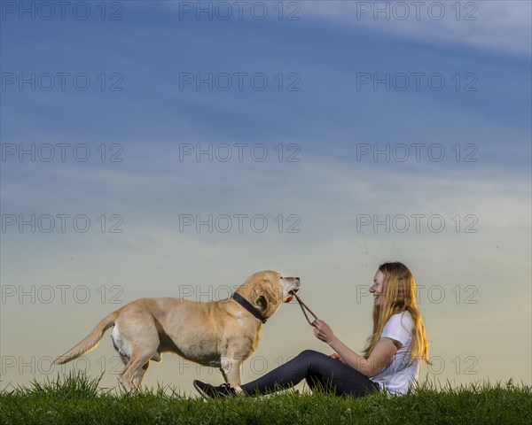 Young woman playing with dog