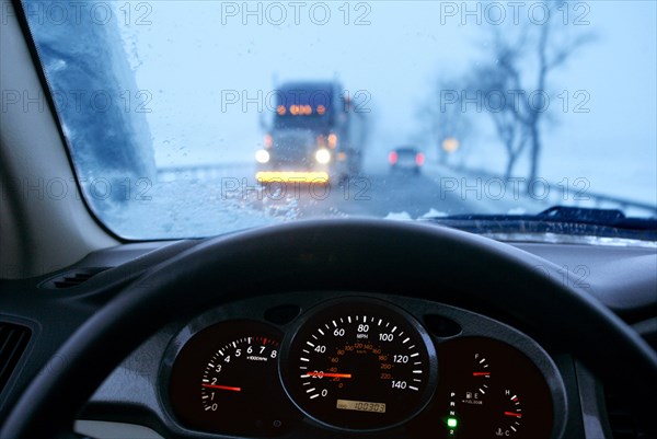 Dangerous Driving on a snowy road in a storm