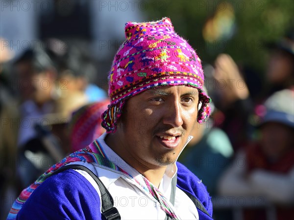 Portrait of an indigenous man in traditional traditional costume during a parade on the eve of Inti Raymi