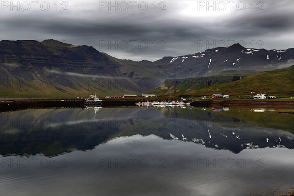 Fishing village in front of mountains