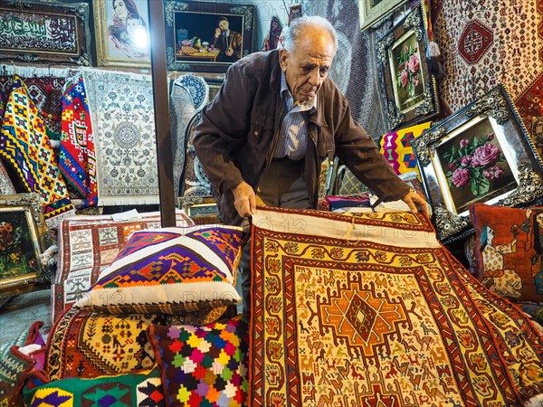 Carpet dealer presents carpets in Vakil Bazaar