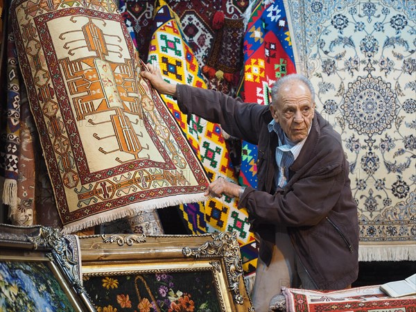 Carpet dealer presents carpets in Vakil Bazaar