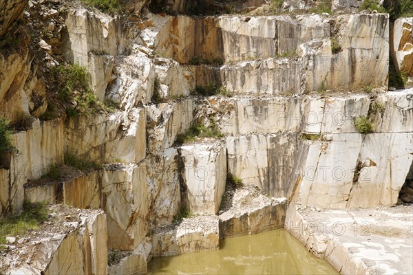 Terraced rock face in open pit carrara marble mines or quarries