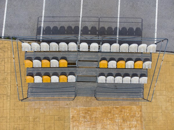 Aerial view of small stands next to parking lot with seats for spectators at a fooball pitch in Altea La Vella
