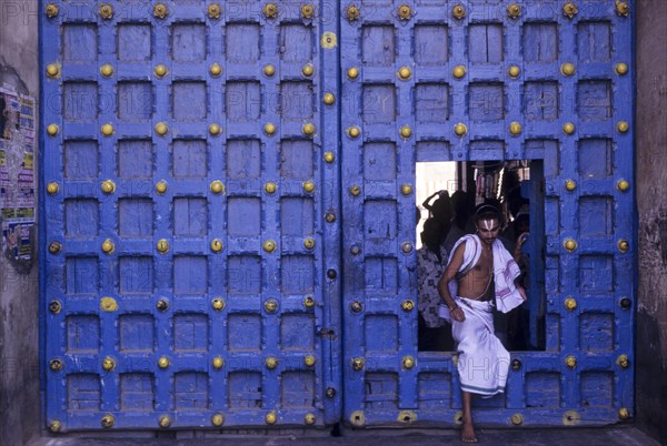 Temple priest crossing the Main door in Varadarajaswamy temple