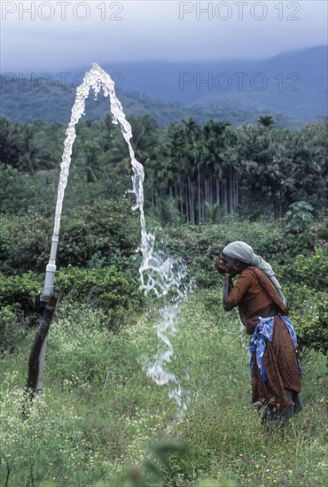 A woman drinking borewell water at Anaikatty near Coimbatore
