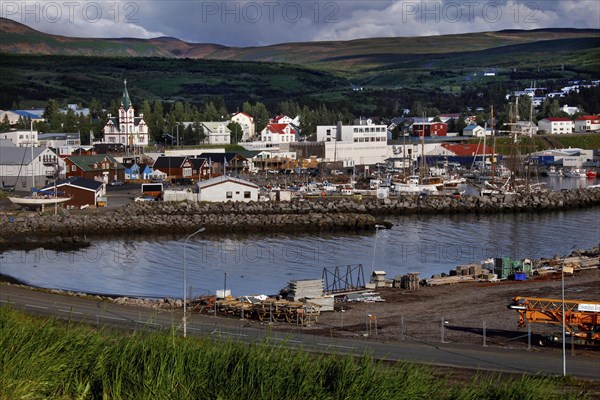 Town with harbour in front of mountain scenery