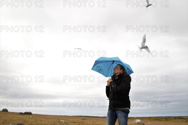 Woman with blue umbrella