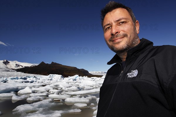 Man in front of icebergs