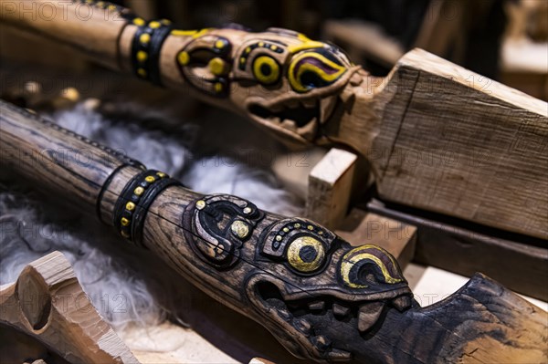 Wooden sculptures in a reconstructed long house in the Lofotr Viking Museum