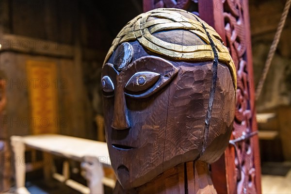 Wooden sculptures in a reconstructed long house in the Lofotr Viking Museum