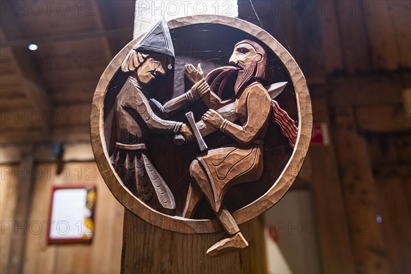 Wooden sculptures in a reconstructed long house in the Lofotr Viking Museum