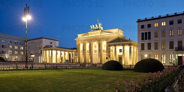 Illuminated Brandenburg Gate with Pariser Platz in the evening