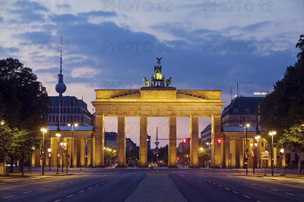 Empty street of June 17 in the morning with the Brandenburg Gate and the Berlin TV Tower