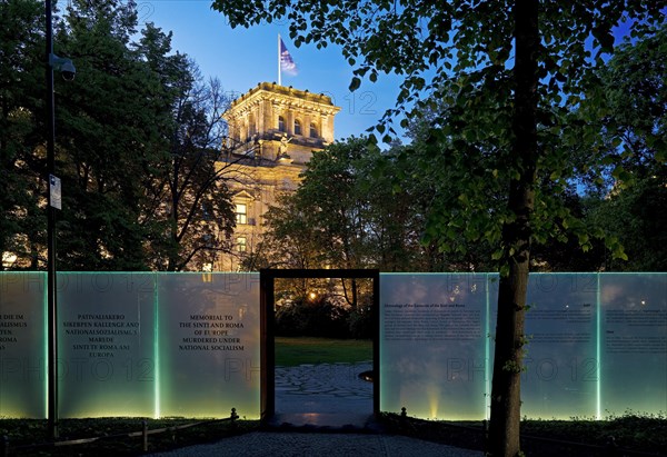 Memorial to the Sinti and Roma of Europe murdered under National Socialism with the Reichstag illuminated in the evening