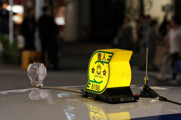 Yellow sign of a cab in downtown