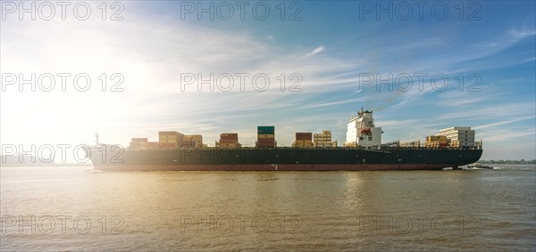 Container ship on the Elbe in Hamburg Blankenese