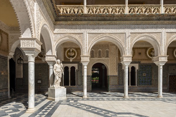Statue in the courtyard with arches
