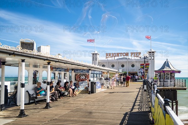 Tourists at Brighton Palace Pier with seagulls