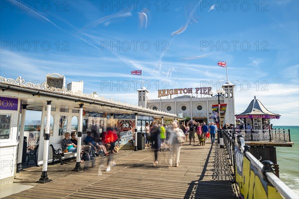 Tourists at Brighton Palace Pier with seagulls