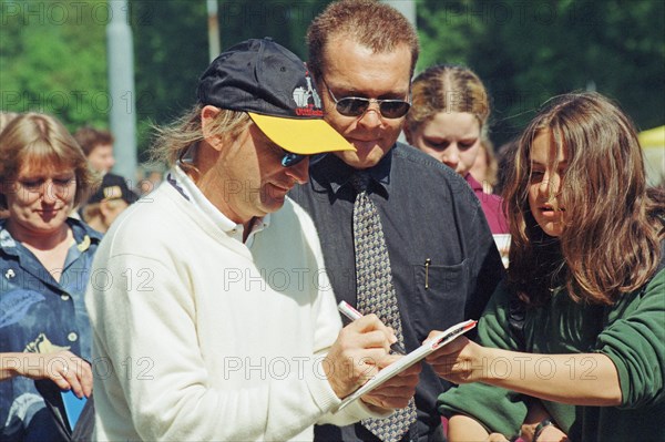 Comedian Otto Waalkes signing autographs on the occasion of a charity match organized by the sports club LSK