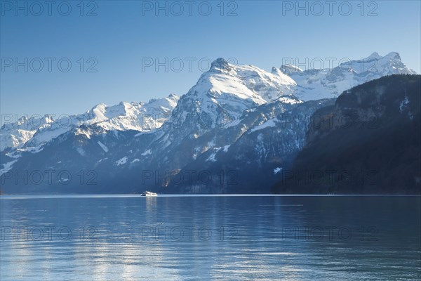 View from Brunnen on a boat on the Lake of Uri in front of the mountain scenery of the Alps of Uri