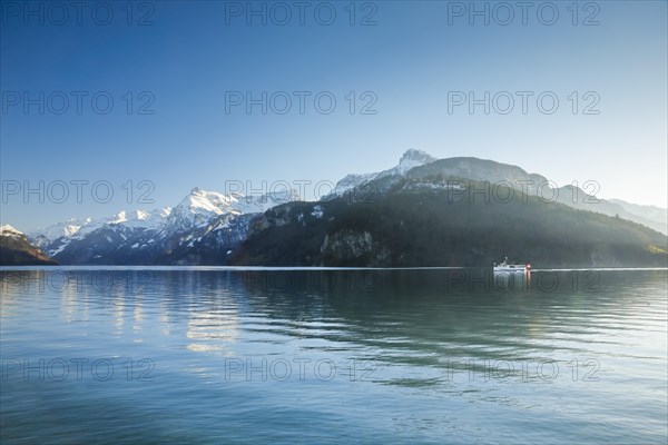 View from Brunnen on a boat on the Lake of Uri in front of the mountain scenery of the Alps of Uri