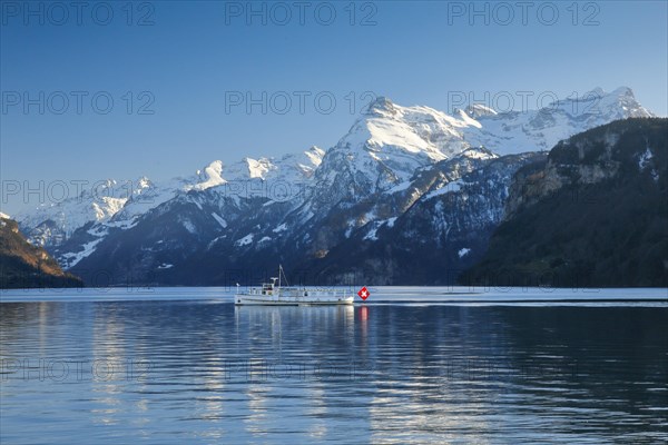 View from Brunnen on a boat on the Lake of Uri in front of the mountain scenery of the Alps of Uri