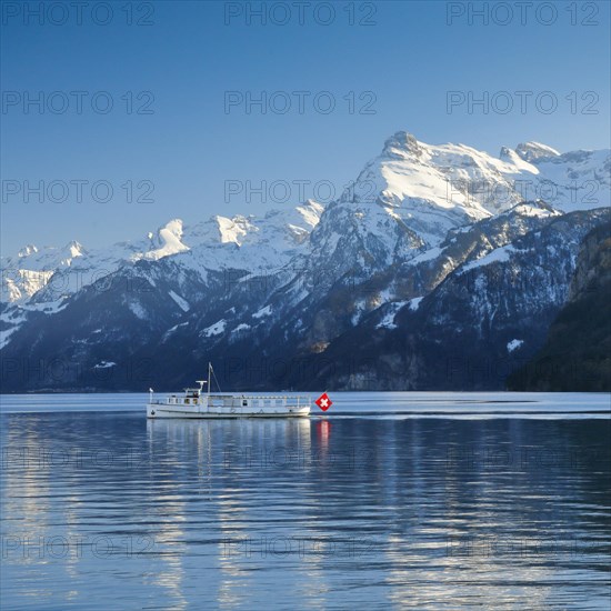 View from Brunnen on a boat on the Lake of Uri in front of the mountain scenery of the Alps of Uri