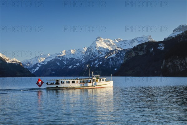 View from Brunnen on a boat on the Lake of Uri in front of the mountain scenery of the Alps of Uri